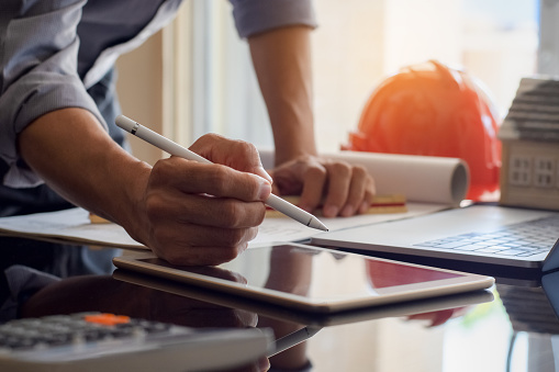 Contractor reviewing project plans and budgets